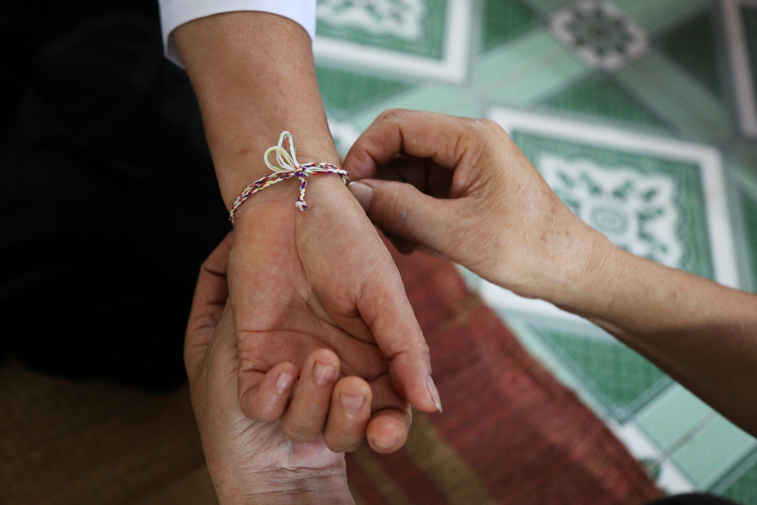 The Muong peoples thread tying around their wrists rituals